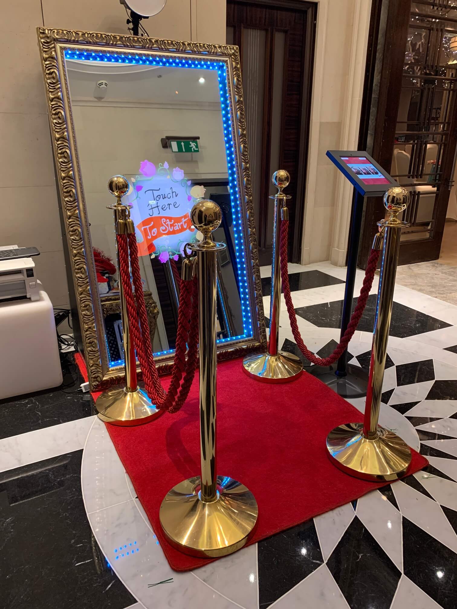 mirror booth with red ropes and carpet